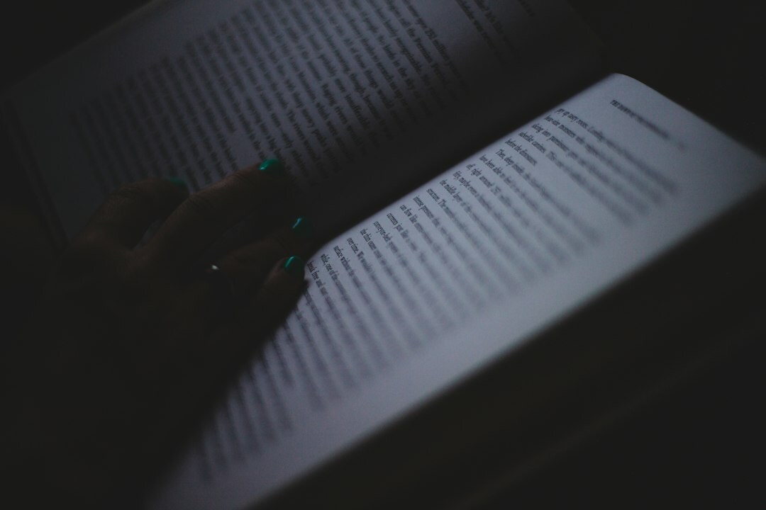 person reading mystery book at night